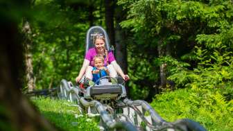 Mère et enfant sur la piste de luge de Floomzer